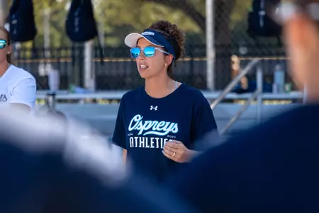 Beach Volleyball head coach speaking to the team during practice