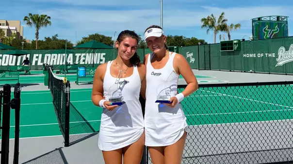 Aryana Bartlett and Gabby Goyins smile for a photo holding trophies