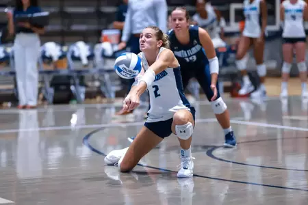 UNF Volleyball players hits the ball.