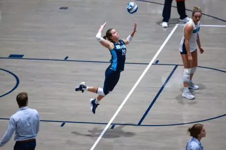 UNF Volleyball player hits the ball.