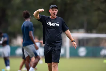 UNF men's soccer assistant coach yells at team before the match.
