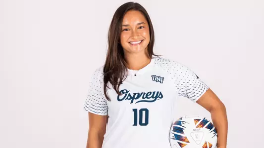 White Backdrop Photo of Paige McSwigan Holding a soccer ball