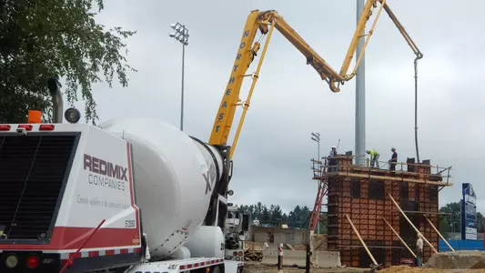 A pump truck delivers concrete to the structure that will support a pedestrian bridge. rupport suopodConcrete gets delivered A concrete pump truck get