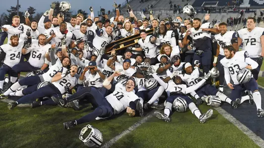 The Wildcats celebrate with the Brice-Cowell Musket after last year's win at Maine.