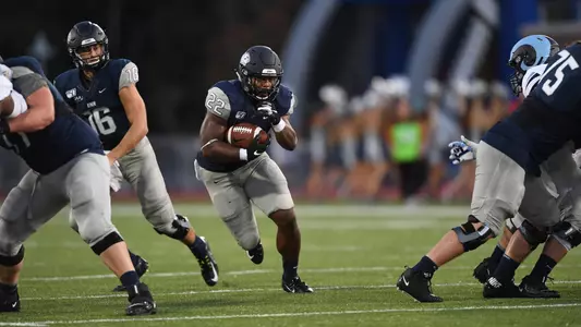 The right side of the offensive line opens  a huge hole for Evan Gray against URI.