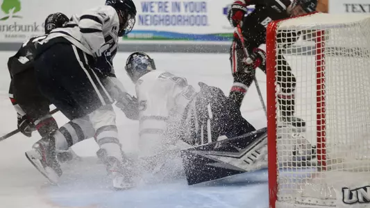 Goalie Ty Taylor covers up a scoring bid in Saturday's win over Brown.