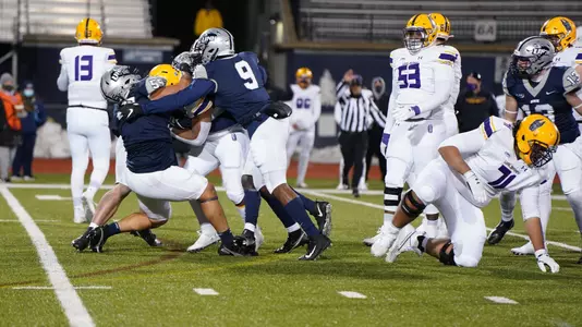 UNH's defensive front swarms Albany's Karl Mofor.