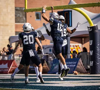 Max Brosmer (20) celebrates his TD run with Dylan Laube (20) and D.J. Linkins (19). (Rick Wilson photo)