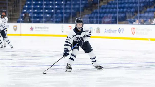 Julia Cabral skates with the puck