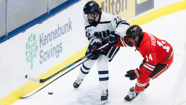 Sofia Kari battles for the puck on the boards.