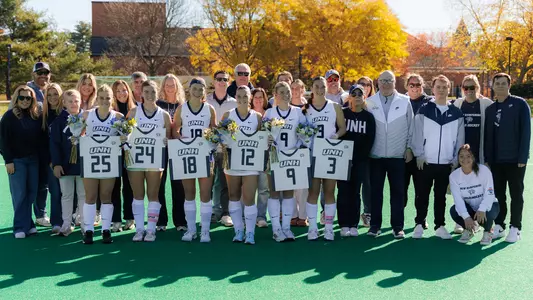 The UNH field hockey 2026 Senior Class with family and coaches (Oct 25)