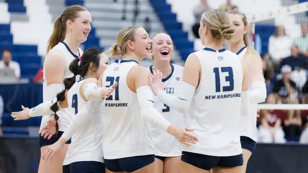 UNH Volleyball team members celebrate a point