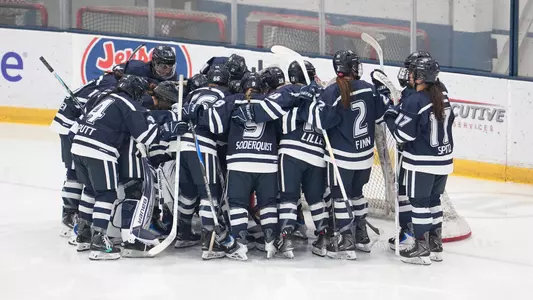 Women's hockey huddles before playing LIU