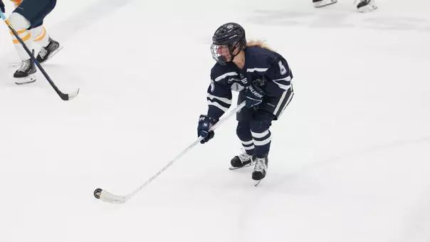 Nina Rossi skates with the puck