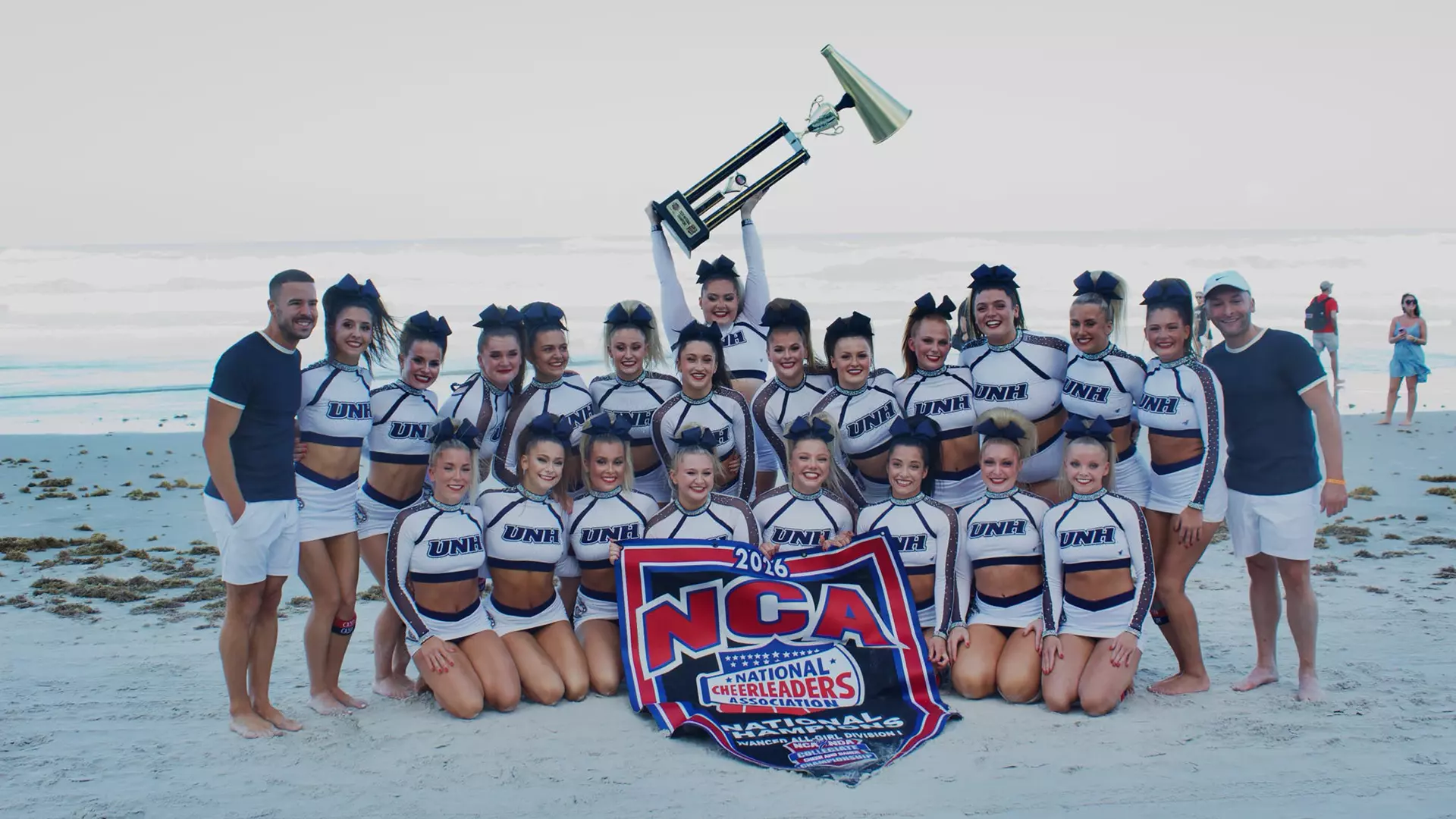 The National Cheerleading Association (NCA) Advanced All-Girl Division I National Champion UNH cheerleading team celebrates on Daytona Beach.