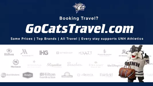 Wild E Cat holds up #1 finger with suitcase in hand to celebrate partnership with ScoreMore