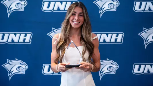 Peyton Novinger poses with her 2026 Most Improved Gymnast award