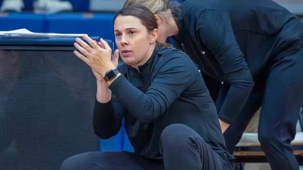 UNH women's basketball head coach Megan Shoniker coaching from the sidelines during the 2025-26 season.
