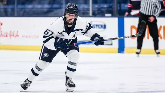 #67 Alyson Hush skates to the puck