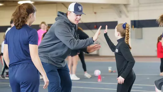 UNH football captain Colby Ramshaw supports a Strong Girls United event