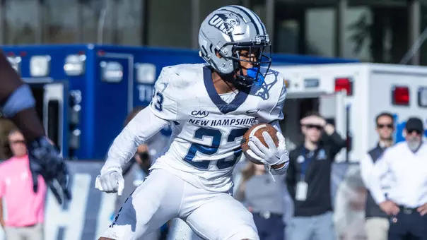 UNH running back Myles Thomason rushing the ball at URI in 2025