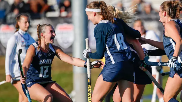 UNH field hockey players celebrate in the 2025 America East semifinal vs. UAlbany at Memorial Field