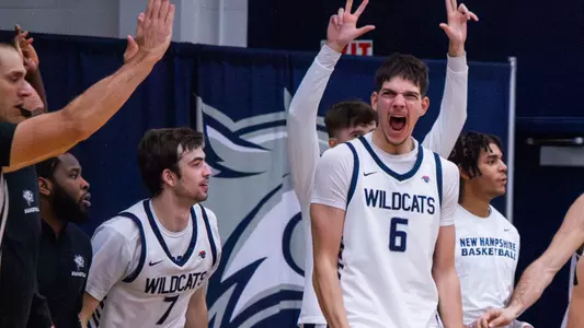 2025-26 UNH men's basketball team bench celebration led by Giannis Xanthopoulos