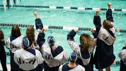 Unidentified members of the UNH swimming and diving team celebrate at Swasey Pool in 2026