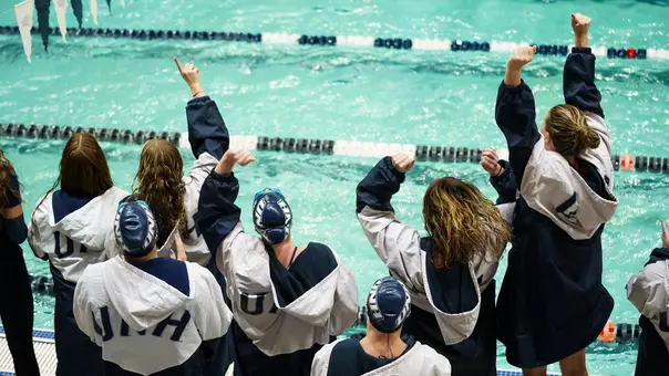 Unidentified members of the UNH swimming and diving team celebrate at Swasey Pool in 2026