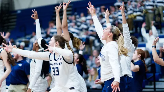 UNH women's basketball bench players celebrate made 3-point basket during 2025-26 season