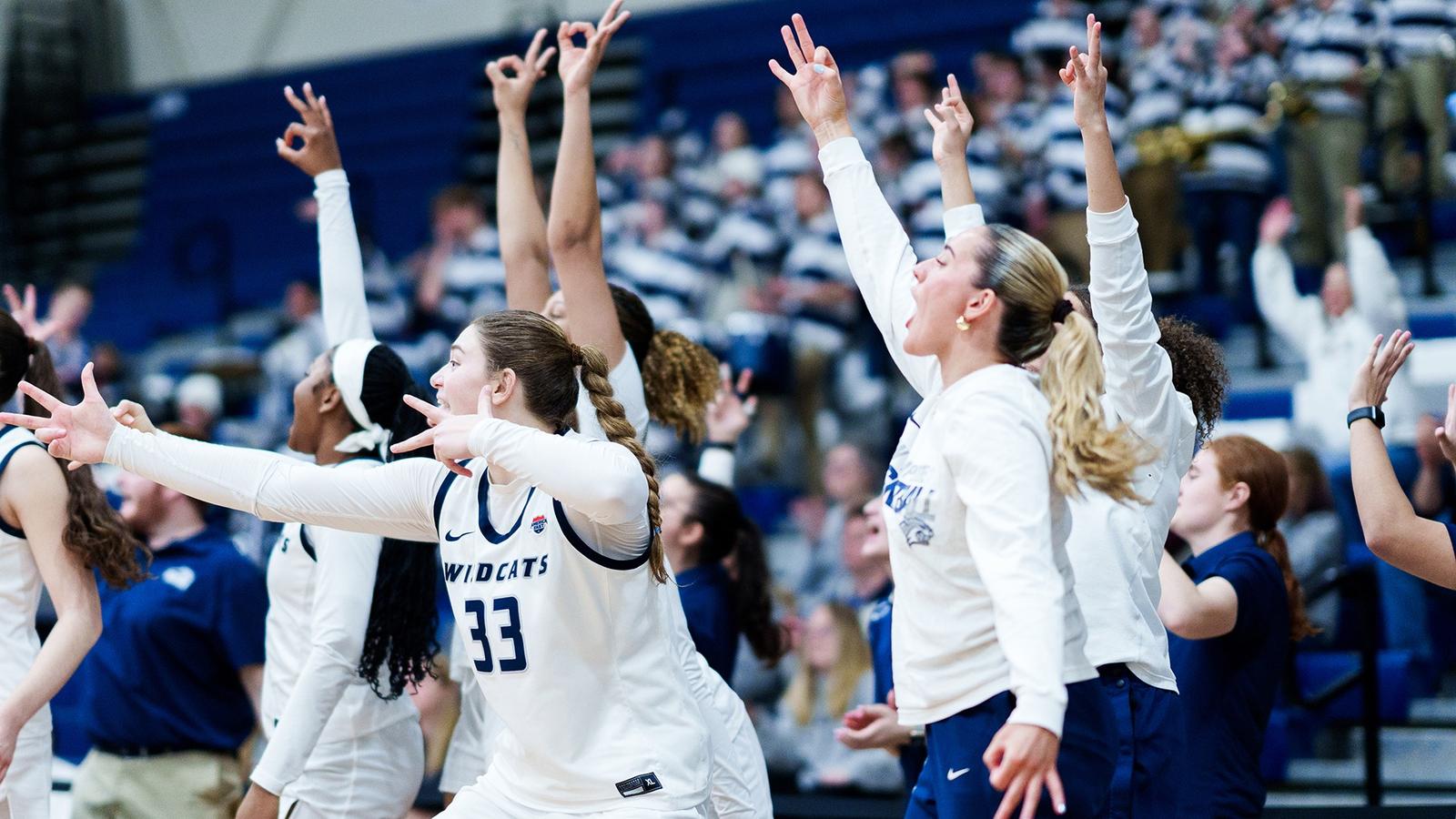 UNH women's basketball bench players celebrate made 3-point basket during 2025-26 season