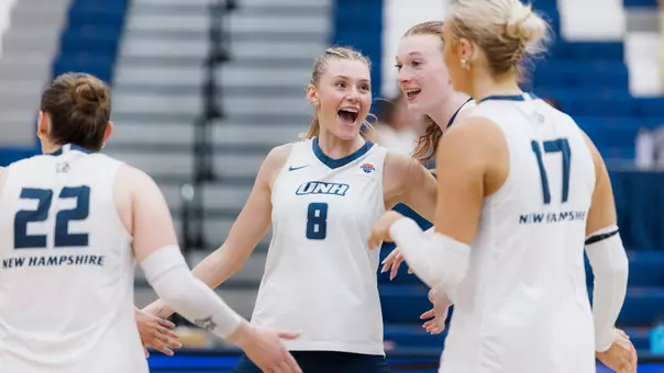Emma Converse celebrates with teammates during VB match.