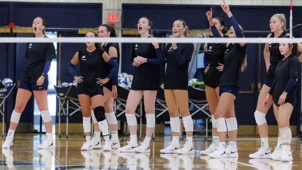 UNH volleyball team cheering at practice