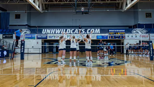 Volleyball teams huddles before a match.