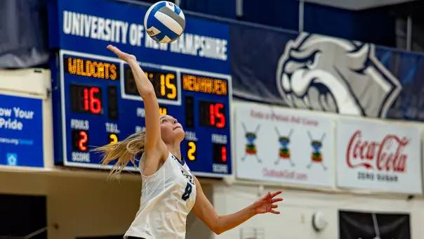 Emma Converse jumps to spike the volleyball.