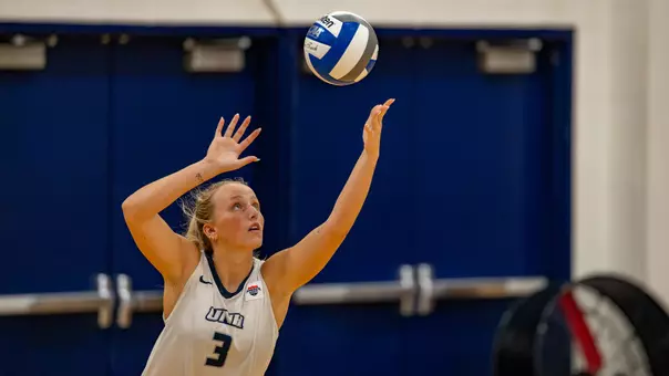 Dylan Hunt serves the ball.