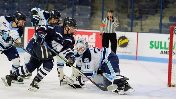 Sydney Leonard skates on net with the puck.