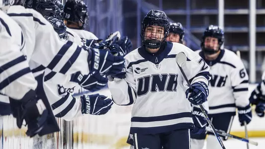 Sadie Makokis (29) celebrates a goal with women's hockey