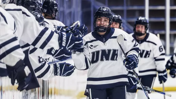 Sadie Makokis (29) celebrates a goal with women's hockey