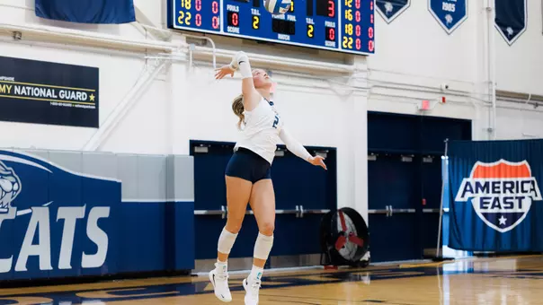 Caitlin Leddy serves the ball.