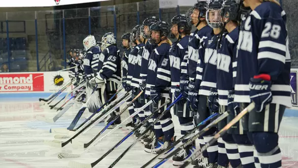 Women's hockey lined up for the start of the game.