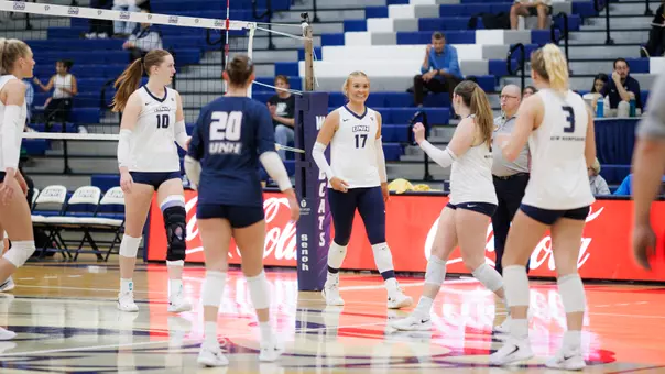 Olivia Maulding and the women's volleyball team celebrate a point.