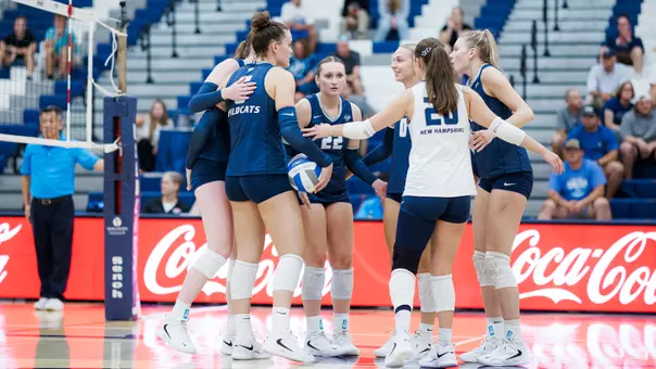 UNH volleyball team in a huddle vs. Providence.