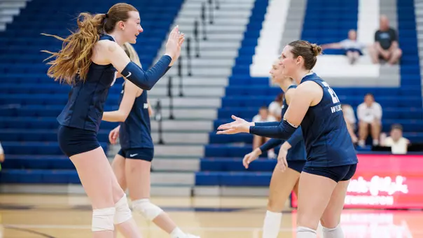 Evelyn Brenton and Jessica Shattles high five after a point.