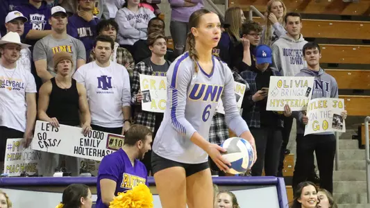 Tayler Alden serving in front of fans