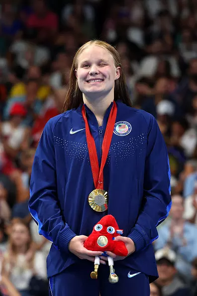 NANTERRE, FRANCE - AUGUST 31: Gold medalist Olivia Chambers of Team United States celebrates on the podium at the Para Swimming Women's 400m Freestyle - S13 Medal Ceremony on day three of the Paris 2024 Summer Paralympic Games at Paris La Defense Arena on August 31, 2024 in Nanterre, France. (Photo by Alex Davidson/Getty Images)