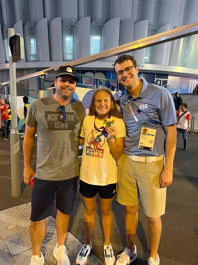 Olivia Chambers with UNI swim coaches Nick Lakin (left) and Ben Colin (right).