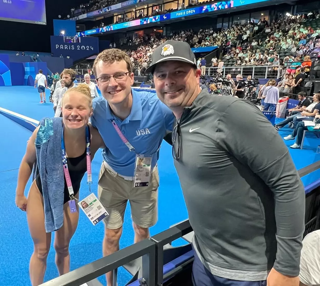Olivia Chambers with UNI swim coaches Nick Lakin (right) and Ben Colin (middle).