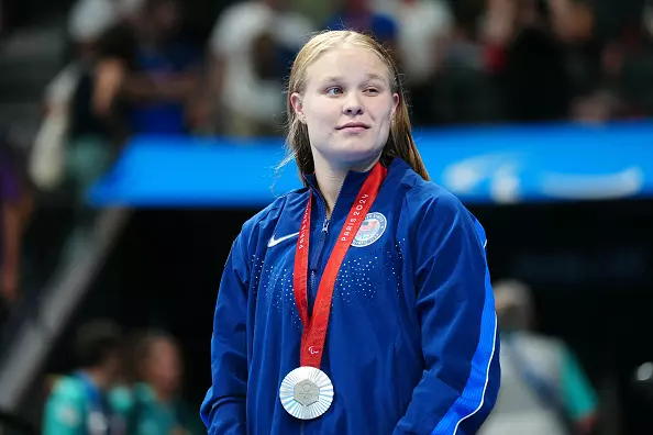 Silver medallist US Olivia Chambers celebrates during the victory ceremony for the women's SM13 200m individual medley final event at the Paris 2024 Paralympic Games at The Paris La Defense Arena in Nanterre, west of Paris, on September 3, 2024. (Photo by Dimitar DILKOFF / AFP) (Photo by DIMITAR DILKOFF/AFP via Getty Images)