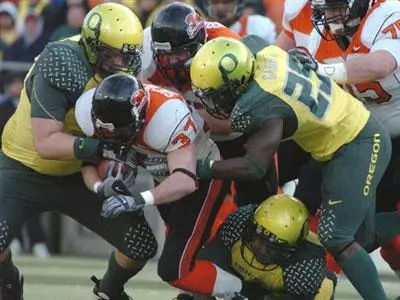 Oregon State's Matt Sieverson is tackled by a crowd of Oregon players